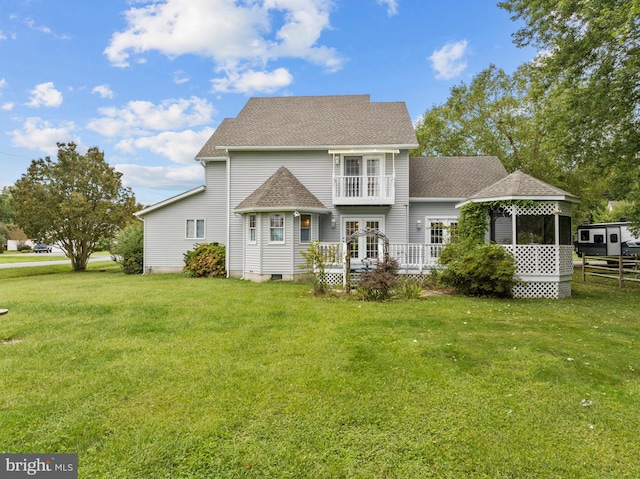 rear view of property with a yard