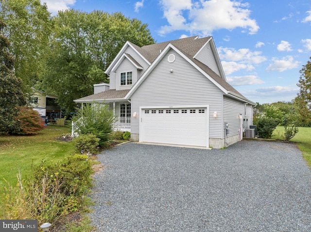 view of front property with a front yard, cooling unit, a porch, and a garage