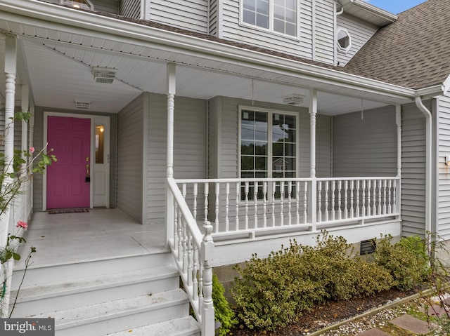 view of exterior entry with a porch