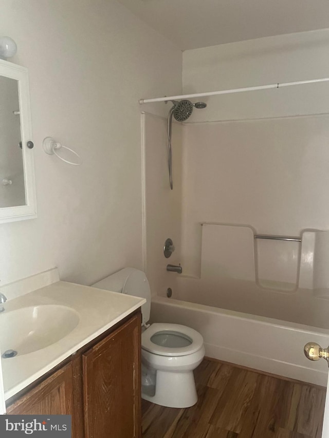 full bathroom featuring vanity, hardwood / wood-style floors, shower / bathing tub combination, and toilet