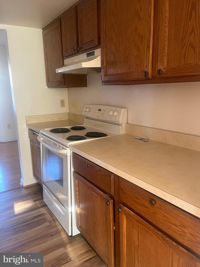 kitchen featuring hardwood / wood-style flooring and white electric stove