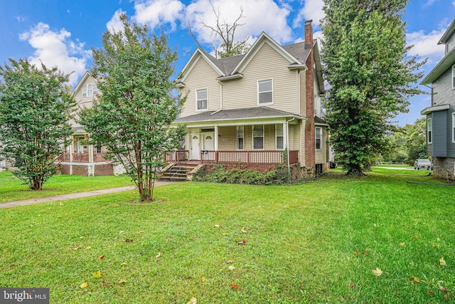 view of front of home featuring a front lawn and covered porch