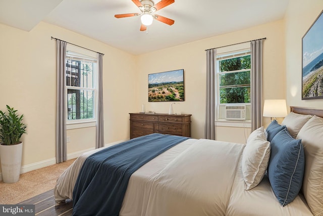 bedroom with cooling unit, carpet, and ceiling fan