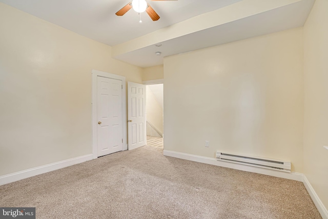 carpeted empty room with ceiling fan and a baseboard radiator