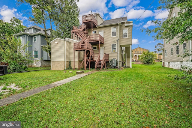 back of house featuring a deck and a yard