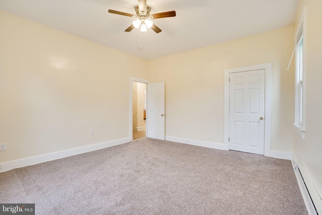 spare room with light carpet, a baseboard radiator, and ceiling fan