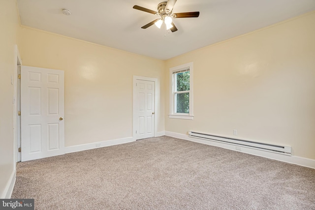 carpeted spare room featuring ornamental molding, ceiling fan, and a baseboard heating unit