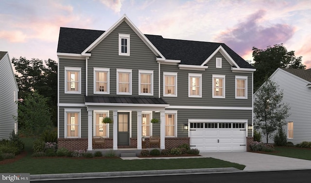 view of front of home with a yard and a garage