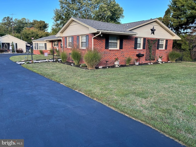 ranch-style home with a front lawn