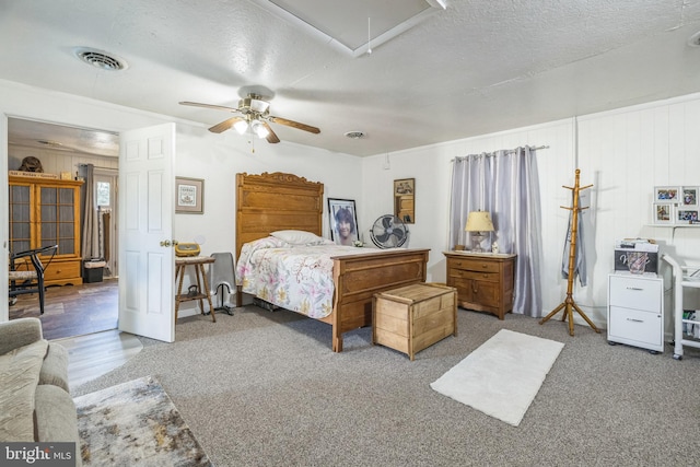 bedroom featuring ceiling fan, a textured ceiling, and carpet flooring