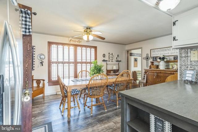 dining area with crown molding, ceiling fan, and dark hardwood / wood-style floors