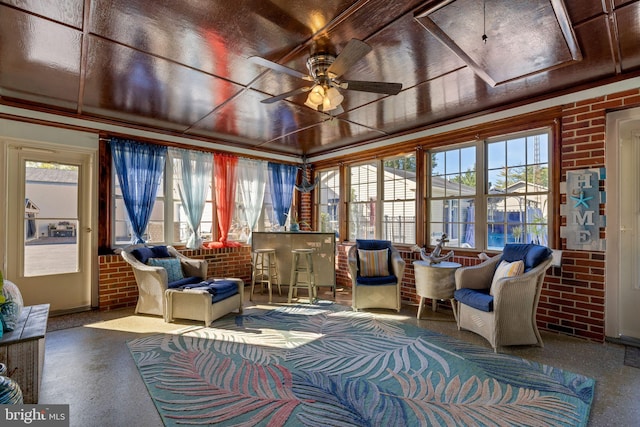 sunroom / solarium with a healthy amount of sunlight and ceiling fan