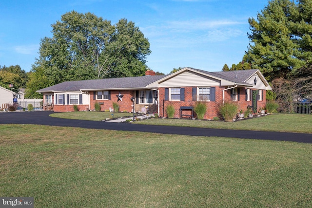 ranch-style home with a front lawn