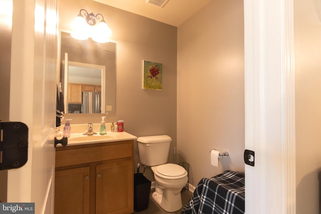 bathroom featuring vanity and toilet