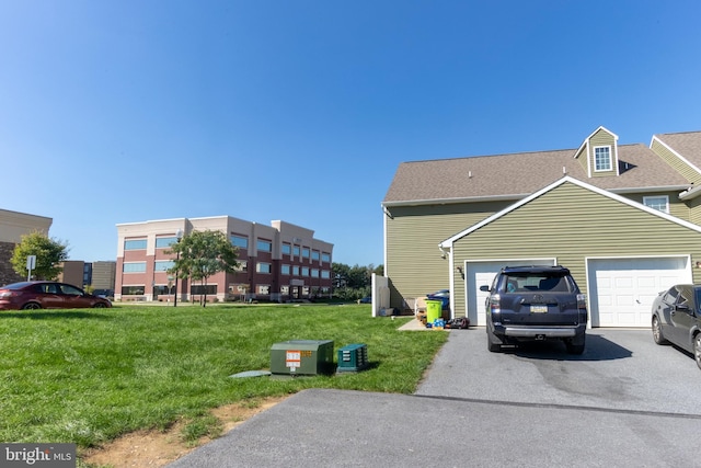 view of side of property featuring a garage and a lawn