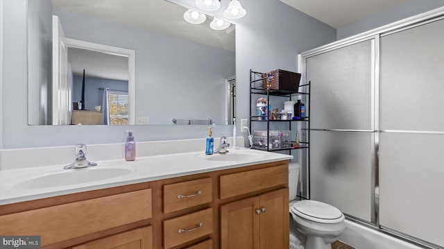 bathroom featuring walk in shower, vanity, and toilet