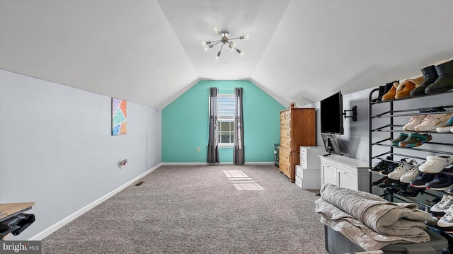 bonus room featuring lofted ceiling, an inviting chandelier, and light colored carpet