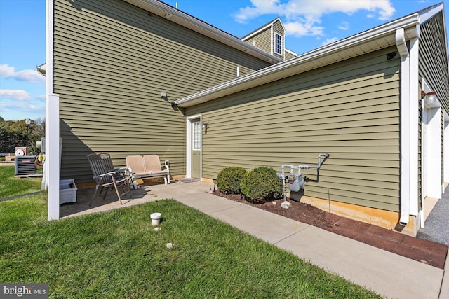 view of property exterior featuring a patio and a lawn