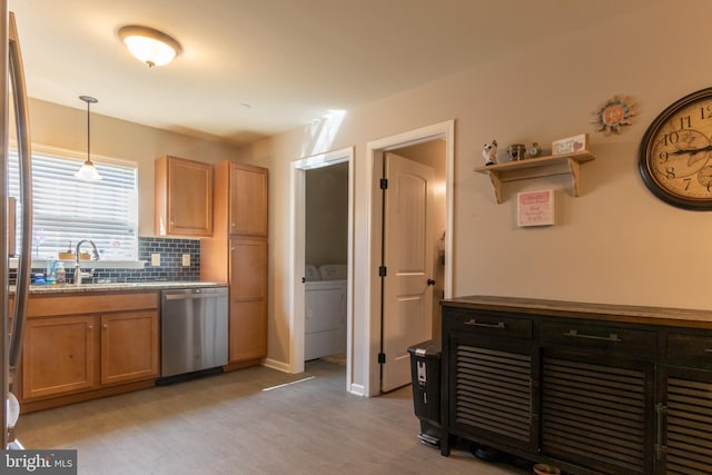 kitchen featuring light wood-type flooring, dishwasher, sink, pendant lighting, and backsplash