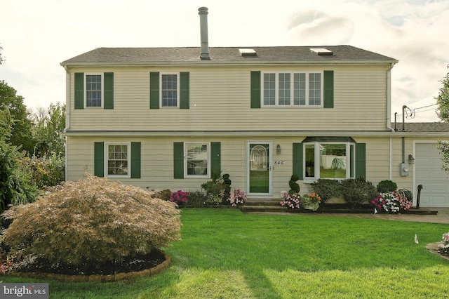 view of front of home featuring a garage and a front lawn