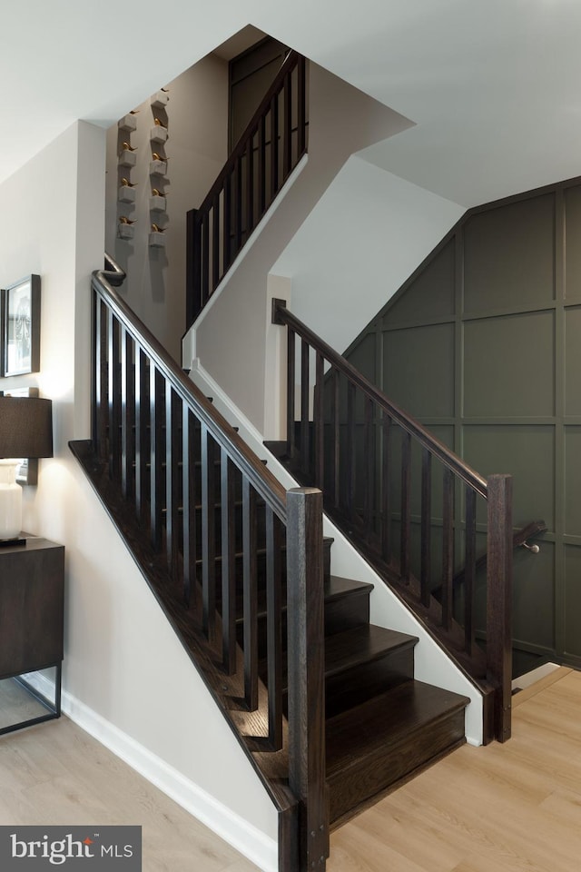 staircase with hardwood / wood-style floors