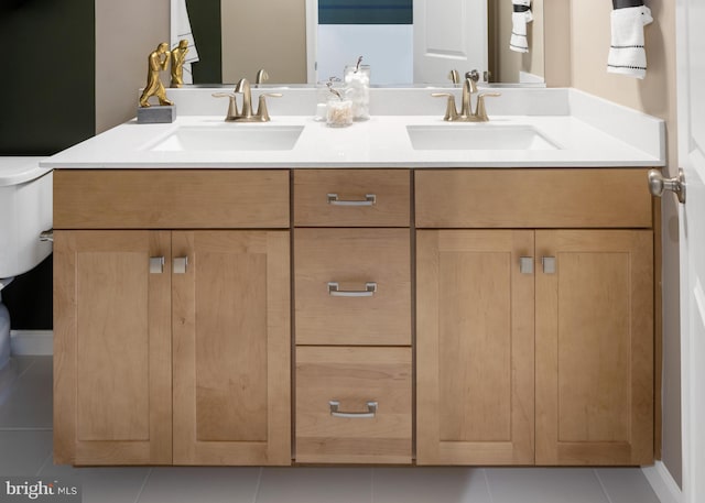 bathroom featuring vanity, tile patterned flooring, and toilet