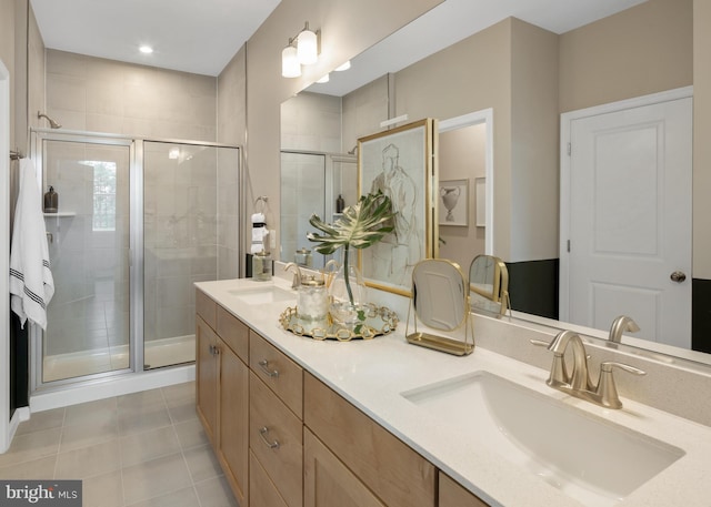 bathroom featuring tile patterned flooring, an enclosed shower, and vanity