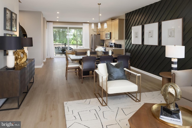 living room featuring light hardwood / wood-style floors and a chandelier