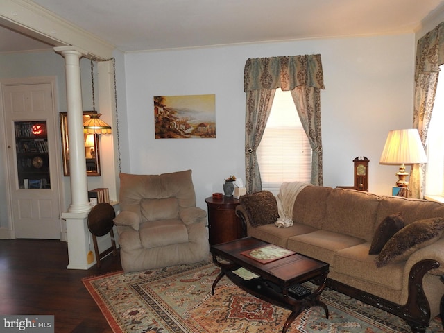 living room with ornamental molding, decorative columns, and dark wood-type flooring