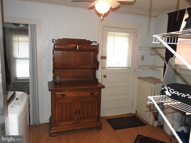 interior space with wood-type flooring, crown molding, and ceiling fan