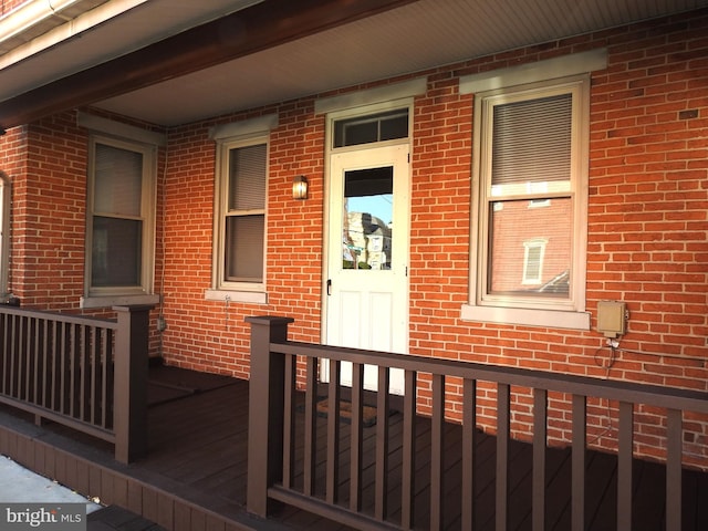 view of exterior entry with a porch