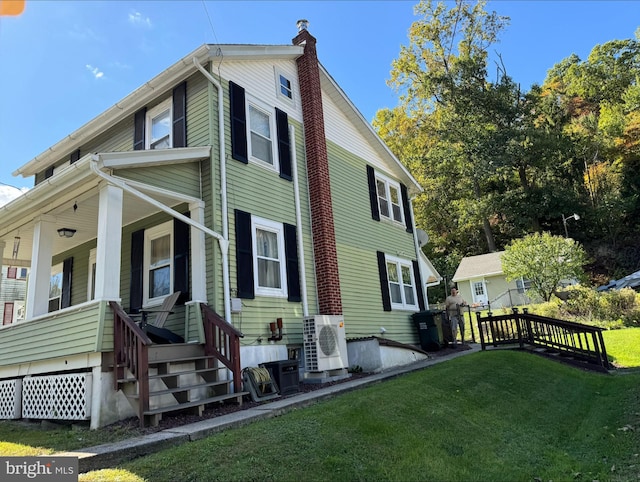 view of property exterior featuring a lawn and ac unit