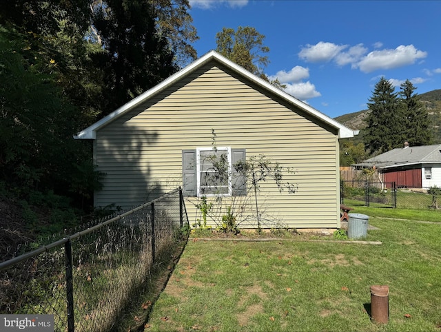 view of side of home with a lawn