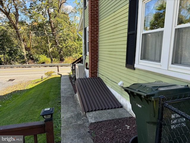 view of side of property with a lawn