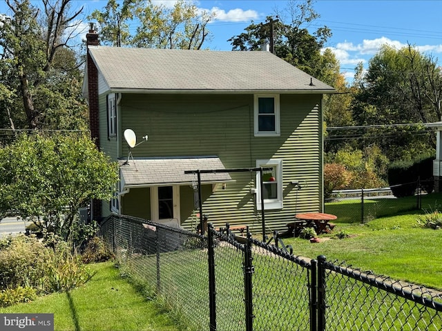 rear view of property featuring a yard