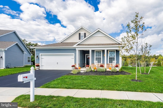 craftsman-style home with a front yard, a garage, and a porch