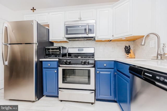 kitchen featuring white cabinetry, sink, blue cabinetry, and stainless steel appliances