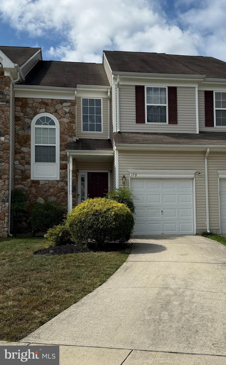 view of front of house featuring a garage and a front lawn