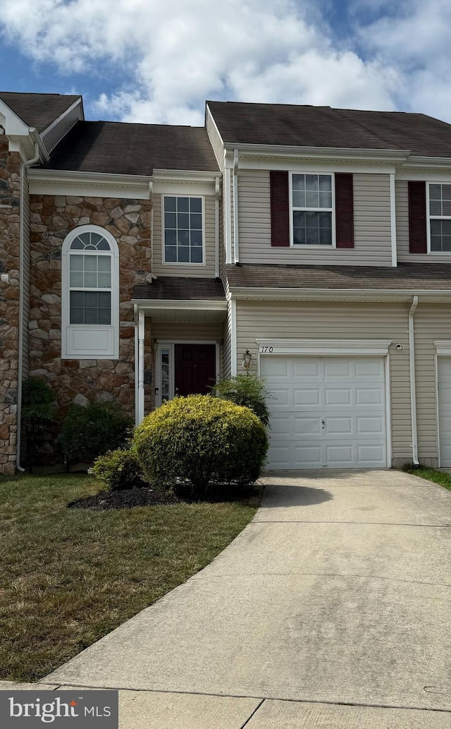 view of front of home featuring a garage and a front lawn