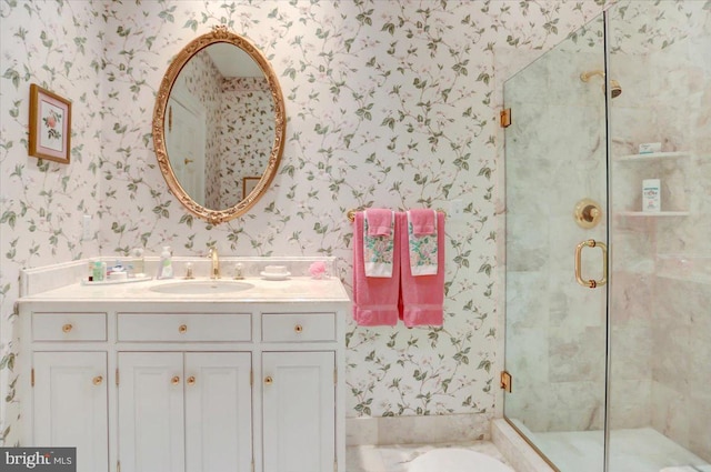 bathroom with vanity and a shower with door