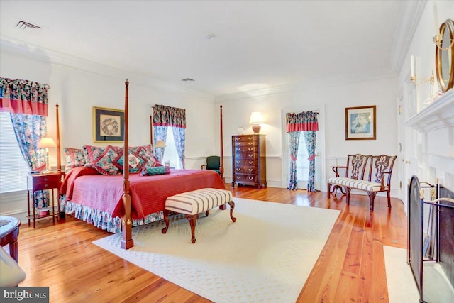 bedroom featuring hardwood / wood-style flooring and ornamental molding