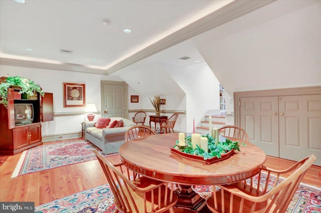 dining area with wood-type flooring and lofted ceiling