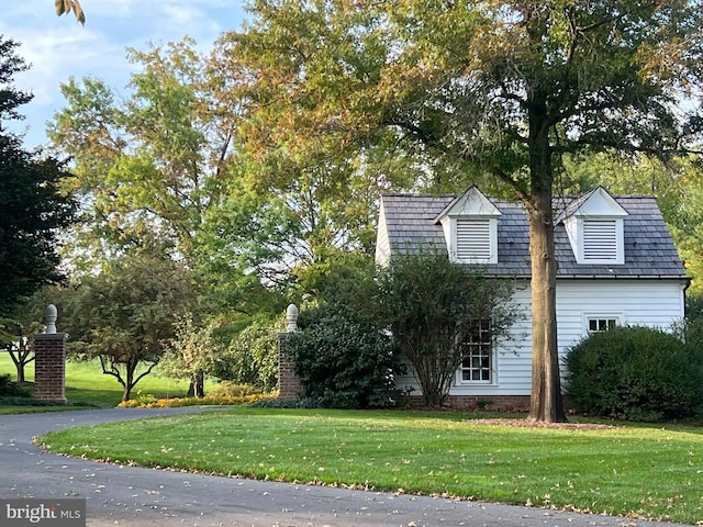 view of side of property with a yard