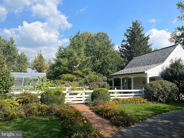 view of home's community with a yard and an outdoor structure