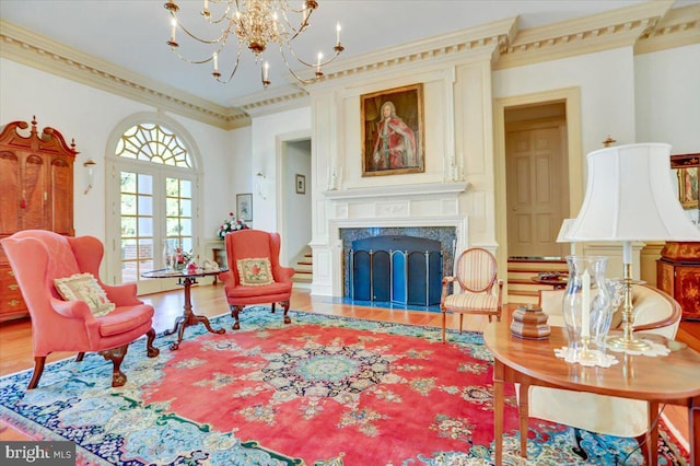 living area with a fireplace, hardwood / wood-style flooring, and ornamental molding