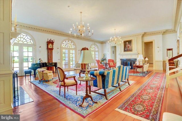 dining space with light wood-type flooring, crown molding, and french doors