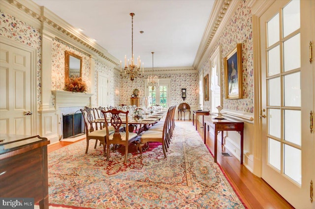 dining room with a wealth of natural light, ornamental molding, and light wood-type flooring