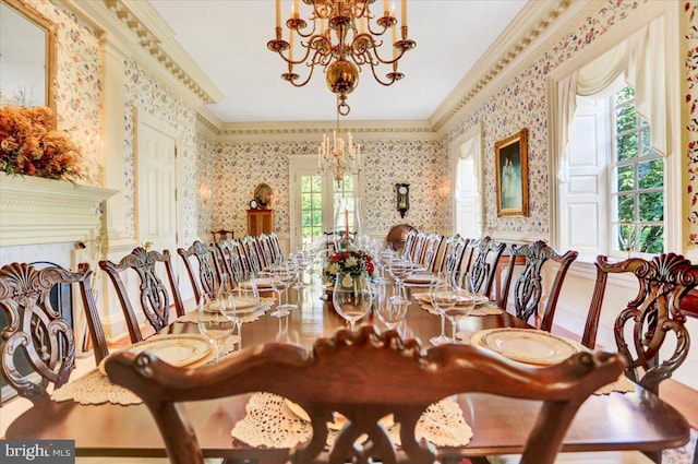 dining room with ornamental molding and a notable chandelier