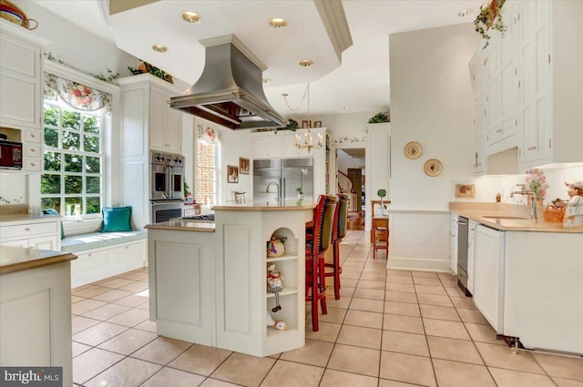 373 Craig Rd, Greencastle, PA 17225 - kitchen with an inviting chandelier, stainless steel appliances, light tile patterned flooring, and island range hood