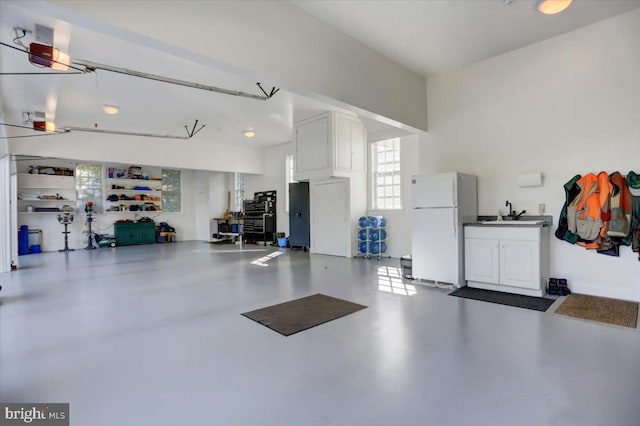 garage with white refrigerator and sink